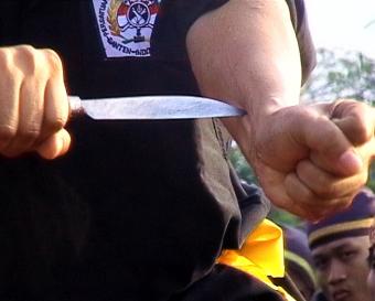 A performance of invulnerability involving members of the Banten    martial arts and culture association. Such groups exercise a    monopoly over the economic and political life of the province / Ian Wilson